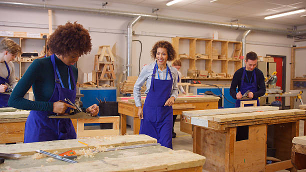 istock Tutor With Carpentry Students In Workshop Studying For Apprenticeship At College 2249306313