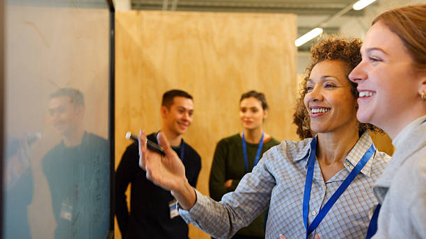 istock Female Tutor Meeting With Students At College Induction Day 2249306327