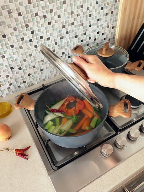 istock Anonymous person prepares vegetable broth at home in kitchen. 2249308240