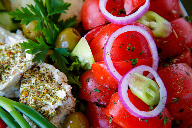 Mixed vegetable salad and cheese on a plate served in restaurant, close-up