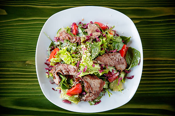 Club Beef steak with pepper sauce and Grilled vegetables on cutting board on dark wooden background. High quality photo