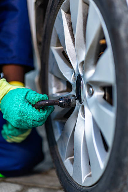 istock Close-up, African mechanic hands changing a car tire in his workshop 2249310240
