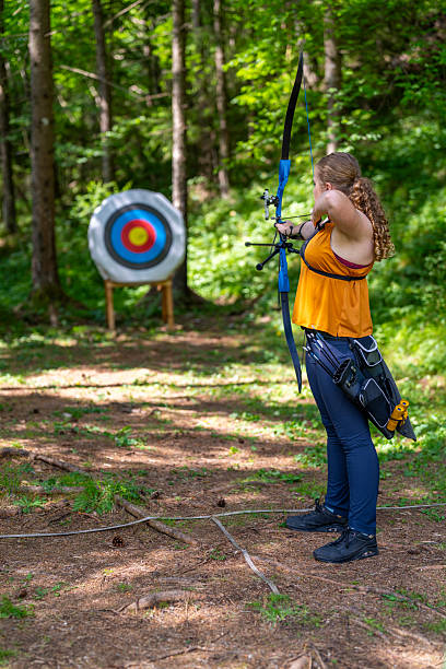 istock Teenage Caucasian Girl Practicing Archery with Focus in Forest Setting 2249311378