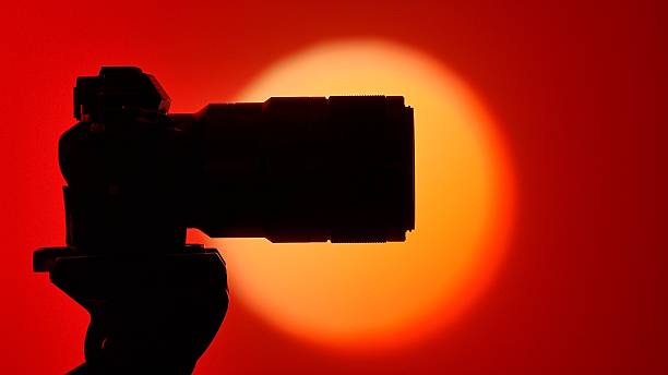 istock Silhouette of Professional Camera Against Red Background 2249312269