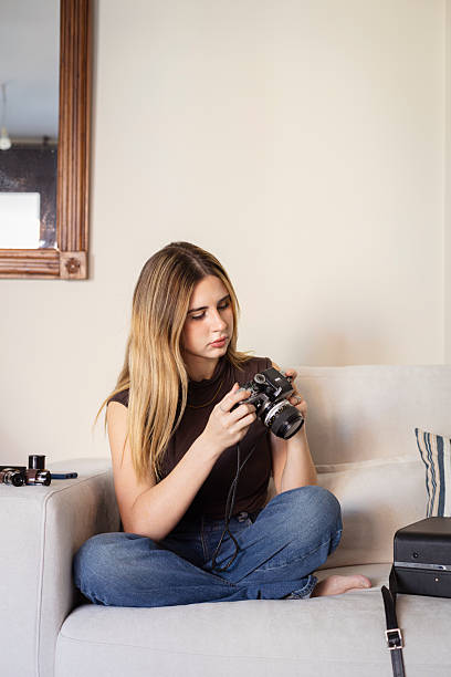 istock Young woman learning photography at home hobby 2249312647