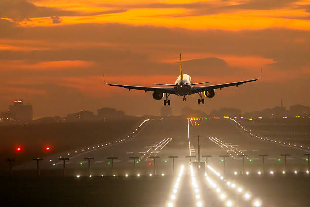 Passenger airplane landing at dusk