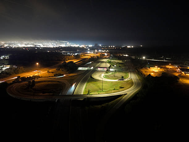 istock : illuminated highway and bridge crossing a river, surrounded by glowing skyscrapers, 2249314739