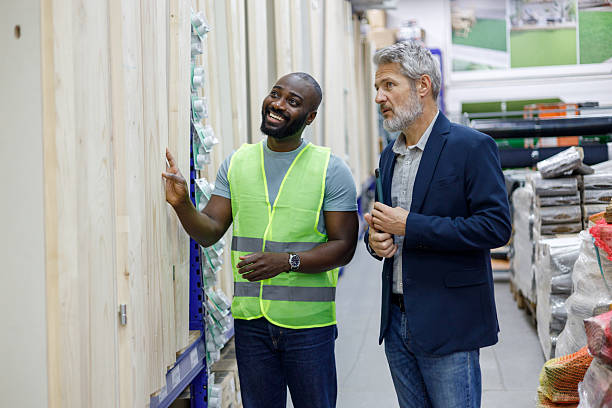 istock Warehouse employee talking to customer about building materials in a large modern retail store 2249316447