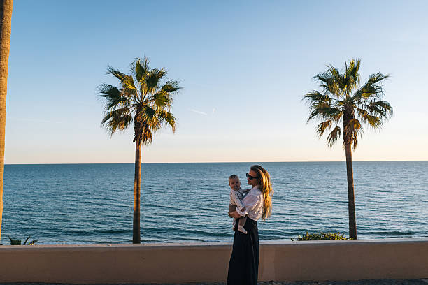 istock Mother holds baby son on seaside 2249318633