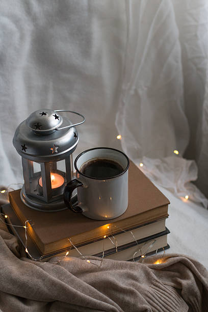 istock Cozy indoor relaxation with coffee, good books and candle. 2249318721