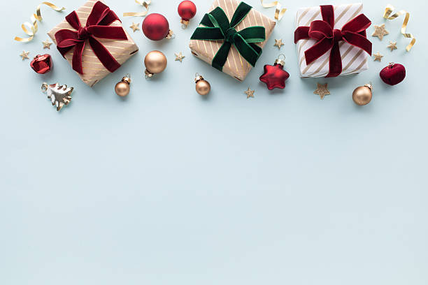 istock Golden gift or present boxes with festive decoration on light blue background for Christmas or New Year greeting card 2249319203