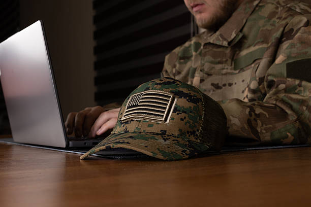 istock A soldier in uniform is working on a laptop at a desk 2249319325