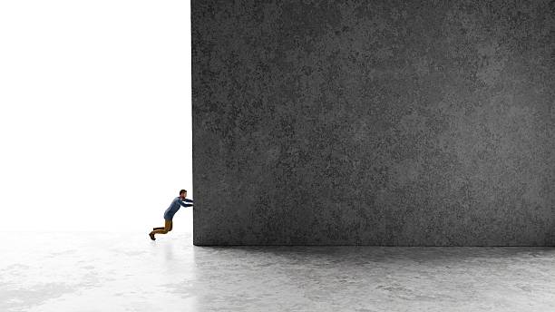 istock Businessman pushing a concrete wall representing business difficulty and challenge concept 2249319425