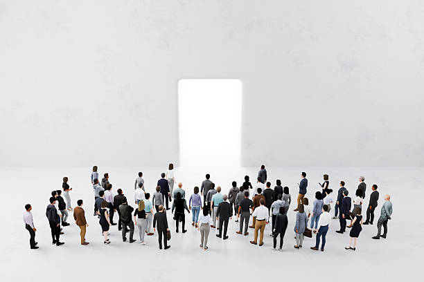 istock Crowd gathering in front of bright opening in a wall. Opportunity and positive change 2249321150