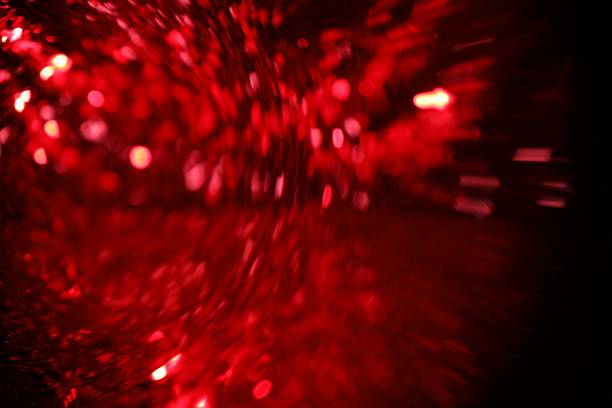 Blurred view of festive lights on black background. Bokeh effect
