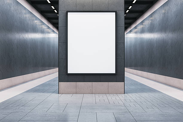 istock Vertical blank poster frame mounted on black tiled wall in modern exhibition hallway with spotlight lighting and clean symmetrical design view. 3D Rendering 2249322621