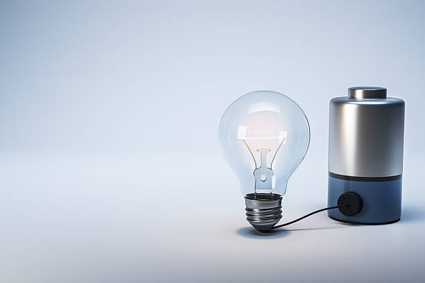 istock Creative concept of glowing lightbulb connected to battery representing electric power and innovation on gradient background. 3D Rendering 2249323054
