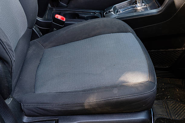 istock Front car seat with textured upholstery and seatbelt latch beside rugged floor mat 2249323822