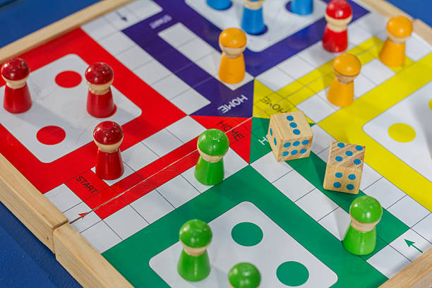 istock Ludo board game with wooden playing pieces and dice. 2249326568