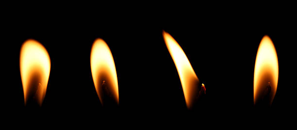 istock set candle flame is burning at night in close range, yellow light isolated on a black background. Concept for taking graphics for birthdays, Halloween, and Christmas. glow wick 2249329374