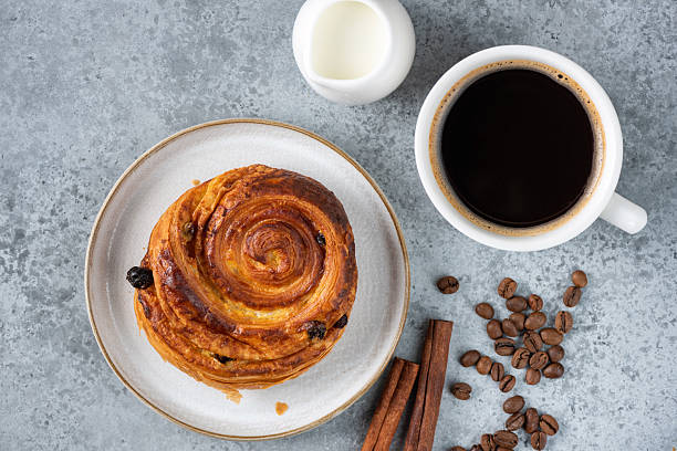 istock Black coffee and raisin cinnamon bun 2249329485