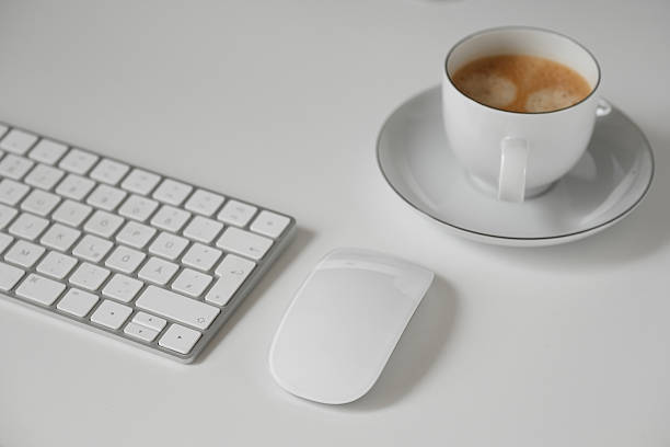 Office desk with laptop computer and red apple on top