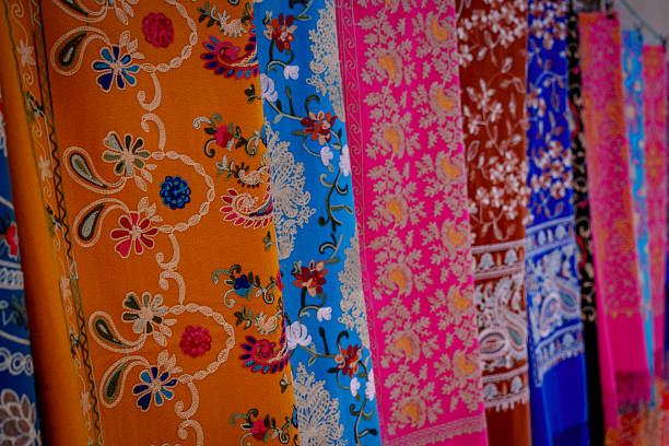 istock Colorful traditional patterned fabrics hanging in row at market 2249330791
