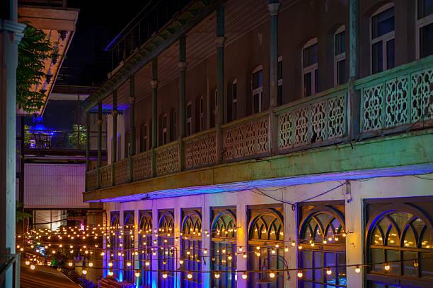 Colorful courtyard balconies with hanging string lights at night