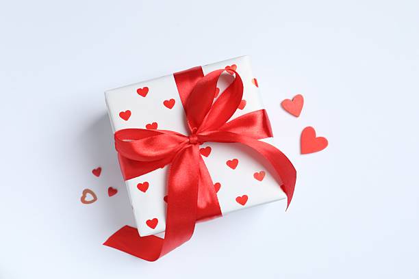 istock Festive gift with red hearts on white background 2249334164