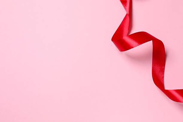 istock Beautiful red silk ribbon on pink background 2249334262