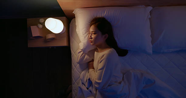 istock asian woman sleepless night at home 2249334757