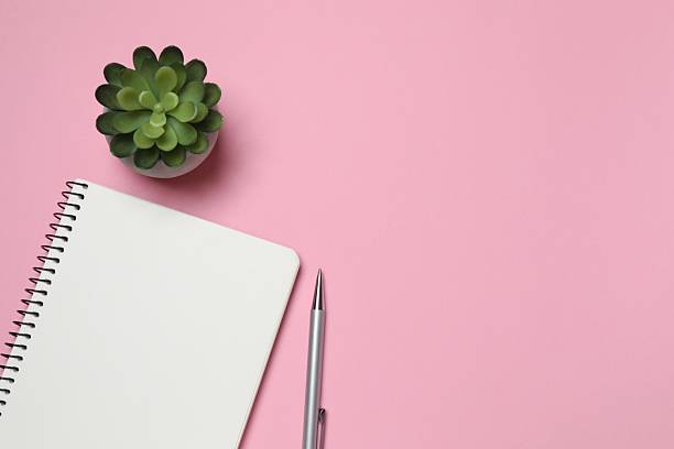 istock Flat lay with pen, green plant and notebook on color background, top view 2249334944