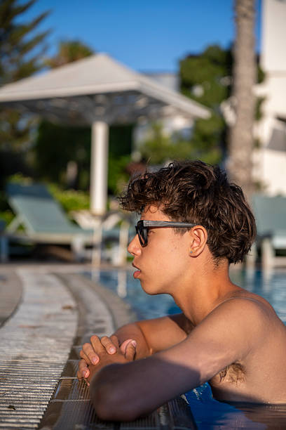 istock Youth Resting by Pool in Warm Sunlight 2249335409