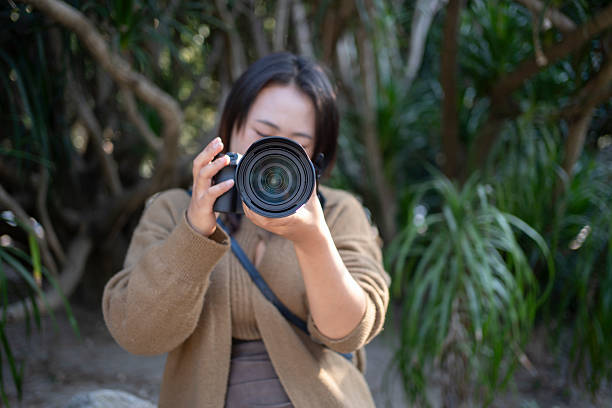 Young Asian women taking photos with cameras