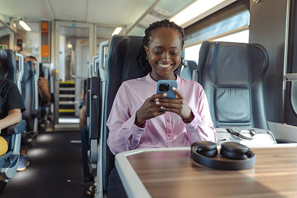 istock Young woman on a train commuting for work smiles at her phone during a comfortable journey 2249336636