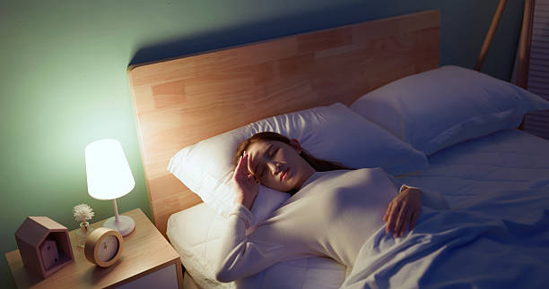 istock asian woman too bright light sleepless night 2249337044