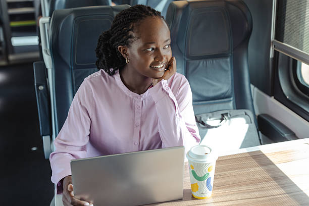 istock Young woman travels by train, working on a laptop with coffee, capturing a modern commuter lifestyle 2249337569