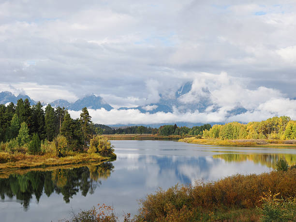 istock Panoramic view of Snake River bend reflecting Teton peaks and cloudy sky 2249338706