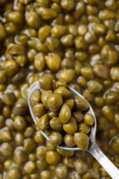 Close-up of pickled capers on background. Healthy food ingredient