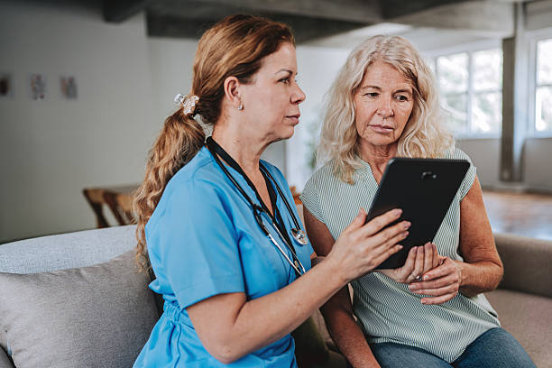 istock Mature nurse using digital tablet to consult with senior patient at home 2249341716