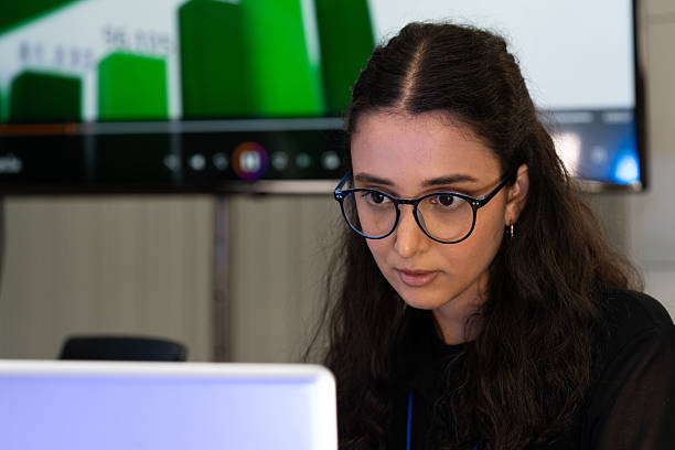 istock Focused businesswoman working on computer in modern office. Professional female analyzing data and concentrating on project tasks, representing productivity, technology, and corporate success. 2249342694