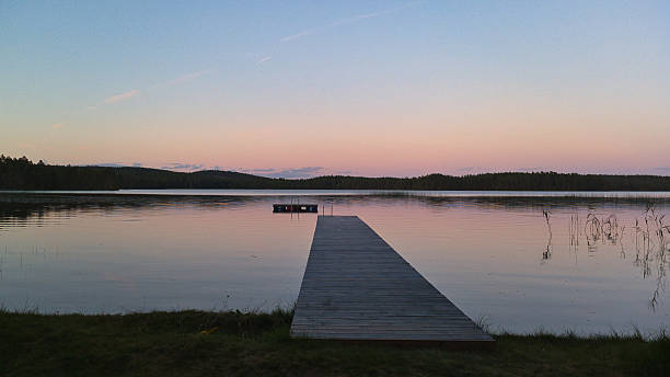 istock Romantic jetty on the lake at sunset with calm water 2249343924