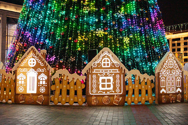 istock Colorful christmas tree with illuminated gingerbread houses at night 2249343957