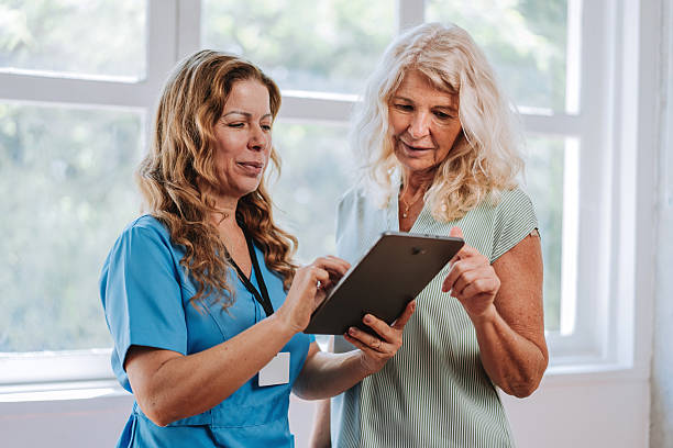 istock Nurse Guiding Senior Woman Through Information on Digital Tablet 2249344721