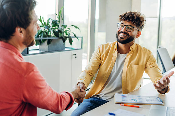istock Successful businessmen shaking hands working on workplace in modern office, planning project 2249347401