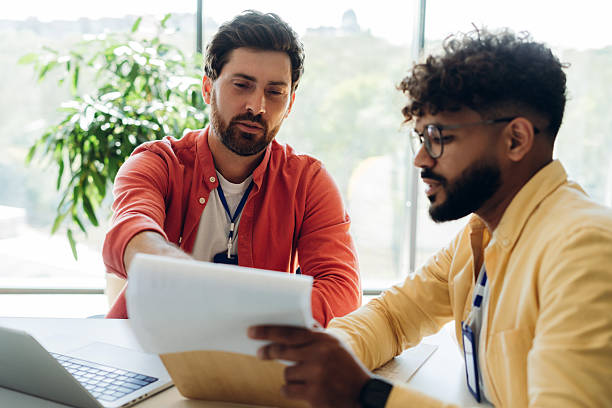 istock Successful colleagues working, taking notes, holding clipboard, sitting working in modern office 2249347456