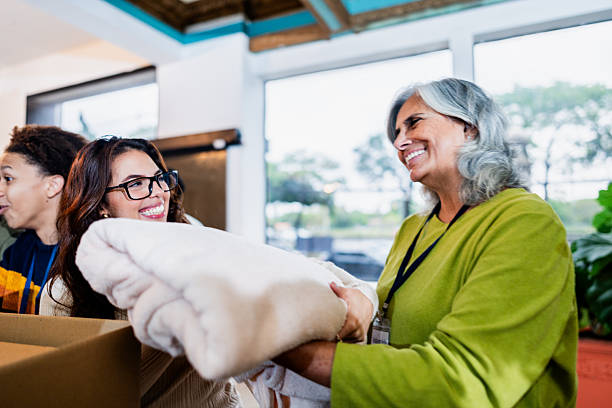 istock Community volunteers sorting clothing during donation event 2249348047