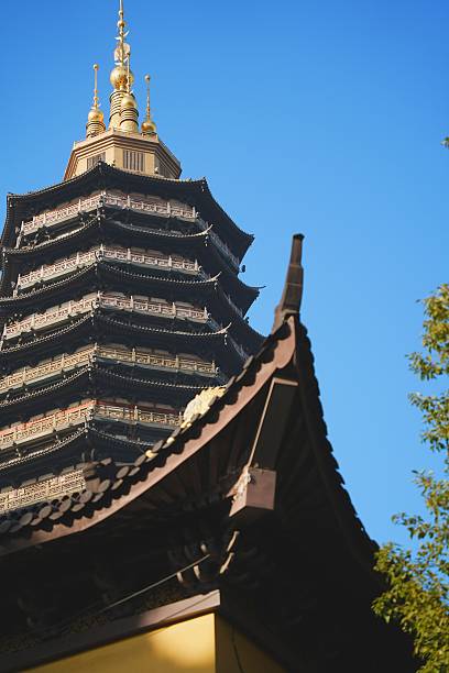 istock Traditional pagoda with ornate details against a clear blue sky in a serene setting. 2249353096