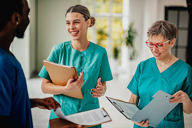 istock Healthcare workers engage in positive teamwork while discussing patient care in a modern hospital setting 2249353413