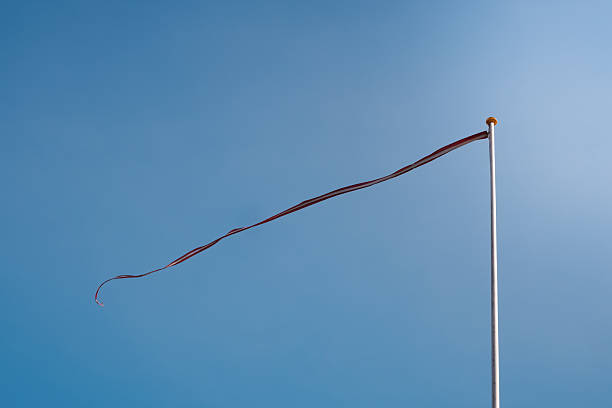 Wind flag flying in the wind on blue sky. flag under blue sky